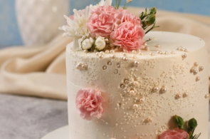 a white cake with pink flowers on top of it