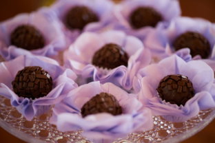 Chocolate truffles arranged in purple wrappers